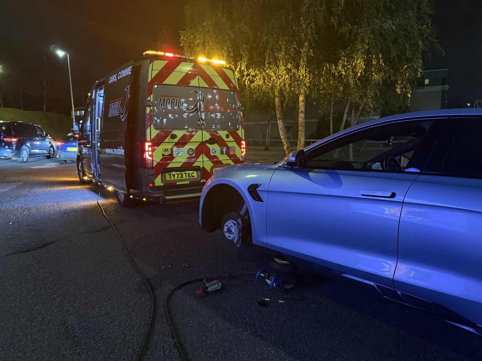 Mobile Tyre Tech van beside a car during a night-time tyre job