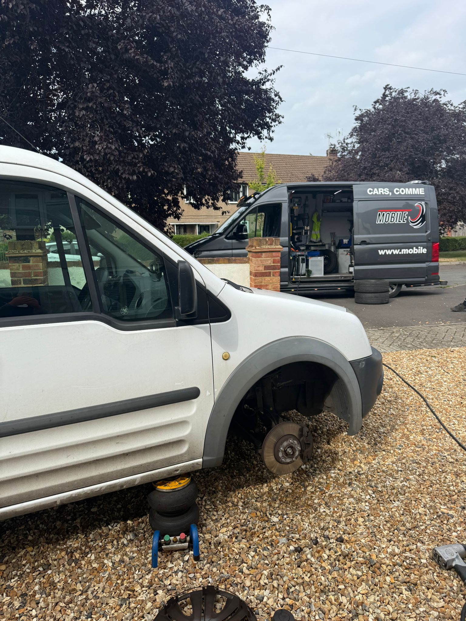 Mobile tyre fitting van and a customer van on a driveway